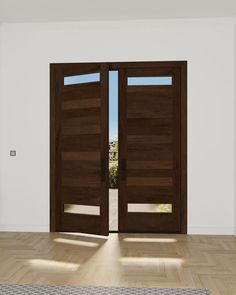 an empty room with two wooden doors and a rug on the floor in front of it