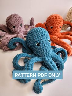 three crocheted octopus stuffed animals sitting next to each other on a white surface