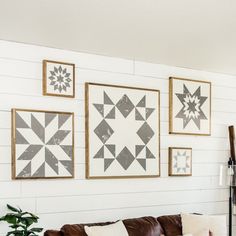 a living room filled with furniture and pictures on the wall