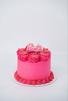 a pink cake with the word barbie on top