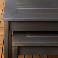 two wooden tables sitting next to each other on top of a wood floored floor