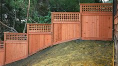 a large wooden fence next to a pile of dirt