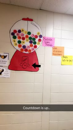 a bulletin board on the wall in a classroom with words written below it and an image of a gumball machine