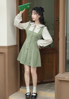 Faux two-piece pinafore blouse dress with a scallop collar, button front and mini twirl skirt. Concealed back zipper with waist ties. S: 14" across shoulders, 35" chest, 28" waist, 32" lengthM: 14.5" across shoulders, 36.5" chest, 29.5" waist, 32" lengthL: 15" across shoulders, 38" chest, 31" waist, 32" length Spring Workwear Pinafore Dress With Buttons, Spring Workwear Fitted Pinafore Dress, Long Sleeve Suspender Dress For Spring, Fitted Suspender Dress For Spring Workwear, Preppy Buttoned Dresses For Spring, Spring Mini Length Fitted Pinafore Dress, Spring Doll Collar Dress With Buttons, Vintage Doll Collar Mini Dress For Spring, Spring Vintage Mini Dress With Doll Collar