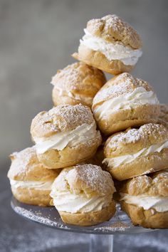 a pile of doughnuts sitting on top of a cake plate