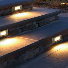 three lights are on the steps outside at night