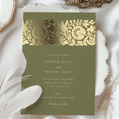 an elegant wedding card with gold foil on the front and green paper in the back