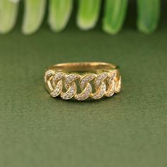 a close up of a gold ring on a green surface