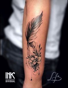 a black and white photo of a feather with flowers on it's arm, done by