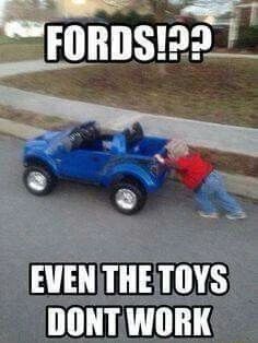 a person pushing a toy car on the street with words that read, fords? even the toys don't work