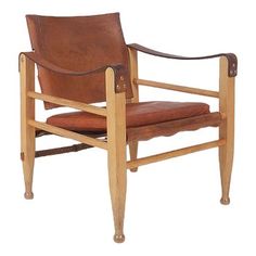 a brown leather chair sitting on top of a wooden frame