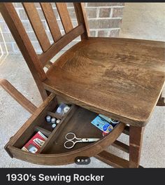 a wooden rocking chair with sewing supplies in the bottom drawer and below it is a brick wall