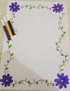 a white paper with purple flowers on it and two pens in the corner next to it