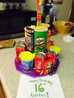 a birthday cake made out of cans on top of a counter