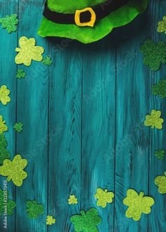 green hat and shamrock leaves on wooden background royalty photo