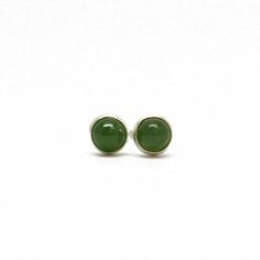 Tiny green Jade stud earrings!  These round nephrite jade cabochons have an attractive olive-green color and subtle veining.  The stones are all natural and untreated. Completely handmade in my studio using all sterling silver or gold fill.  I have hand soldered the bezels to the studs and mounted the stones within them.   These little earrings are hard for me to photograph! The images above are closeups so you can see the details.  I can assure you they are very pretty little green earrings!• 3 Little Earrings, Lampwork Earring, Brown Jewelry, Brown Necklace, Nephrite Jade, Onyx Necklace, Tiny Studs, Tiny Earrings, Tiny Stud Earrings