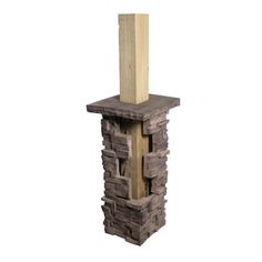 a tall tower made out of wood and stone with a wooden post sticking out of it