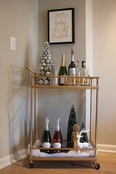 a bar cart filled with bottles of wine and christmas decorations