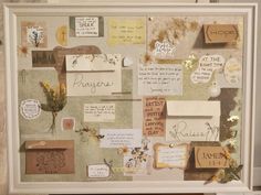 a collage of papers and other things is displayed in a frame