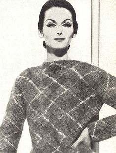 an old photo of a woman wearing a sweater