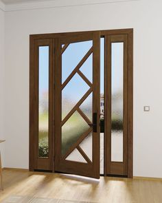 an open wooden door in a white room with wood flooring and glass panels on the doors