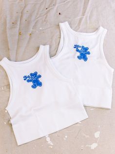 two white tank tops with blue teddy bears on them