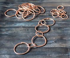 several pieces of copper metal sitting on top of a wooden table