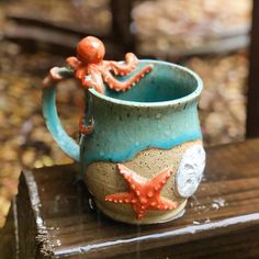 an octopus in a mug sitting on a bench