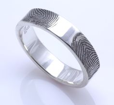 a fingerprint wedding ring on a white background