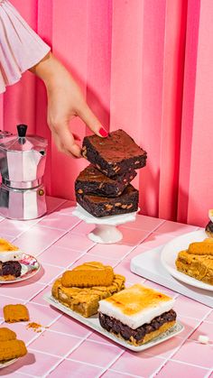 a table topped with desserts and pastries on plates