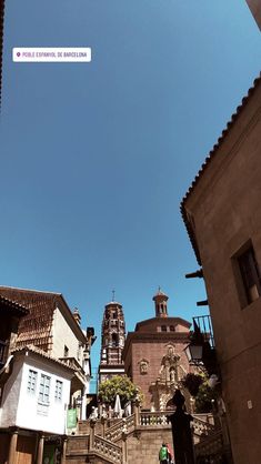 an old building with a clock tower in the background and stairs leading up to it