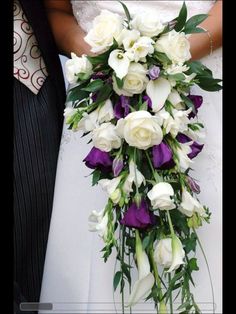 the bride and groom are holding bouquets of white and purple flowers in their hands