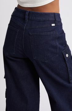 Classic cargo pockets give utilitarian appeal to these wide-leg jeans crafted from breathable low-stretch denim. 33" inseam; 25 1/2" leg opening; 10 1/2" front rise; 15" back rise Zip fly with button closure Front scoop pockets; cargo snap-patch pockets 99% cotton, 1% spandex Machine wash, tumble dry Imported Dark Wash Cropped Leg Cargo Jeans For Work, Utility Cargo Jeans With Cropped Leg, Dark Wash Cargo Style Wide Leg Flare Jeans, Dark Wash Wide Leg Cargo Style Flare Jeans, Denim Blue Wide Leg Flare Jeans With Cargo Pockets, Mid-rise Denim Blue Cargo Jeans For Work, Utility Dark Wash Flare Jeans With Side Pockets, Utility Wide Leg Dark Wash Cargo Pants, Dark Wash Mid-rise Cargo Jeans For Workwear