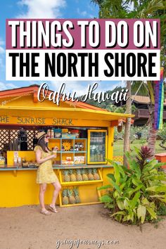 a woman standing in front of a kiosk with the words things to do on the north shore