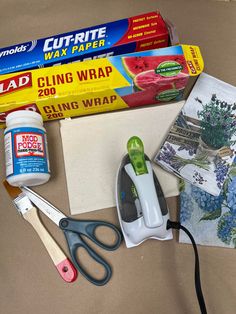 craft supplies laid out on a table including scissors, glue, paper and other items