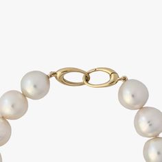 Introducing a top-notch White South Sea pearl bracelet finished with a 14K yellow gold interlocking oval clasp. The pearls mesmerize with their 100% natural color – a radiant white with a soft pink overtone. The pearls are semi-baroque in shape and their sizes vary from 12 to 14 mm. The high luster of the pearls is sure to captivate anyone's attention. With a length of 8" (20cm), this bracelet becomes a versatile accessory for any event, large or small. Will accommodate a wrist size up to 6.5" (16cm). The pearls' surface is 80% clean, bearing a few natural blemishes. These tiny imperfections, the tender kisses from nature, serve as indisputable proof of their authenticity. After all, nature's beauty often lies within these charming nuances. Weighing at 43.9g, this bracelet offers a comfort Luxury Single Strand Pearl Bracelet With Round Beads, Luxury Single Strand Pearl Bracelet, Luxury Round Pearl Charm Bracelet, Luxury Akoya Pearl Bracelet, Luxury Round Pearl Drop Bracelets, Luxury Round Bracelets With Pearl Drop, Luxury Akoya Pearl Bracelet With Round Beads, Classic Yellow Gold Single Strand Pearl Bracelet, Elegant White Oval Link Bracelets