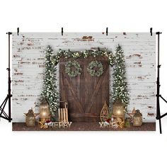 a christmas scene with wreaths and lights on the mantle next to a wooden door