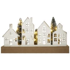 a white christmas village with trees and lights