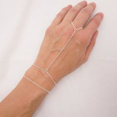 MADE WITH SOLID STERLING SILVER PARTS - A GREAT KEEPSAKEI make this hand chain bracelet using sturdy sterling silver chain and a lobster clasp. Paired in the first two photos with a simple chain bracelet for a layered look. Both can be purchased together as a set or you can purchase just the hand chain bracelet (see 3rd photo). Comes in a gift box, perfect for gift giving. SIZING - IMPORTANT: To determine bracelet size, measure snugly around your wrist and add 1/2 inch to get your bracelet size. Silver Hand Chain, Finger Ring Bracelet, Hand Chain Bracelet, Cool Piercings, Cute Ear Piercings, Pretty Fashion, Bracelet Minimalist, Hand Chain, Body Chain Jewelry