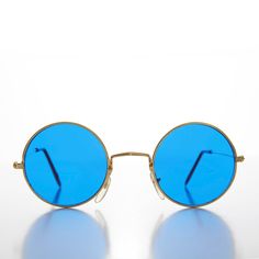 This iconic Rock and Roller sunglass features a round perfect circle, blue tinted lens with a metal frame. New old stock. Never worn. Great condition. UV Protection. NOS deadstock Made in China FIT INFORMATION 45mm Eye Size 26mm Bridge 140mm Temple/Arm Width 5 Inches Height 1 7/8 Inches Shop more Vintage Sunglasses @ https://www.etsy.com/shop/SunglassMuseum Shop more Vintage Reading Glasses @ https://www.etsy.com/shop/RetroVintageReaders Retro Round Sunglasses With Uv Protection, Vintage Round Sunglasses With Uv Protection, Retro Blue Sunglasses With Polarized Lenses, Vintage Round Sunglasses With Mirrored Lenses, Retro Blue Polarized Sunglasses, Vintage Blue Sunglasses For Summer, Blue Vintage Sunglasses For Summer, Blue Round Frame Sunglasses With Mirrored Lenses, Round Frame Tinted Sunglasses For Festivals