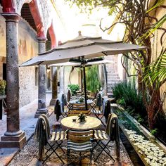 an outdoor dining area with tables and chairs