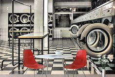 a room that has some red chairs in front of the washer and dryer