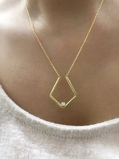 To give a dainty meaningful gift for your loved one you can prefer this geometric ring holder necklace. Or this 8K plain gold ring keeper necklace can be a special treat just for yourself . You can prefer any colour of birthstone on this custom birthstone ring holder necklace. This solid gold geometric pendant jewelry is the best way to present your ring in a safe and expressive manner. *FEATURES We are using real gold in our product for pendant and chain .  Material : 8K Solid Gold  Pendant width : 2.2 cm Pendant length : 2.6 cm Colour : gold  Chain Length : 14''-20'' upon your request  The open necklace laid straight & measured end to end. * PACKAGING Jewels will be sent nicely wrapped and packed in a box! If specific goods are intended as gifts, please leave us a note. We'll use a speci Modern Geometric Jewelry For Anniversary, Minimalist Jewelry With Bezel Setting In Recycled Gold, Minimalist Diamond-shaped Everyday Jewelry, Minimalist Everyday Diamond-shaped Jewelry, Everyday Minimalist Diamond-shaped Jewelry, Modern 14k Gold Jewelry With Single Diamond, Minimalist Diamond-shaped Jewelry For Anniversary, 14k Gold Single Diamond-shaped Jewelry, Elegant Everyday Diamond-shaped Jewelry