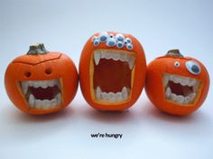 three carved pumpkins with mouths and teeth