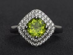 Welcome to my shop, you can find many beautiful gemstone jewelry here, and you also can ask for customized service. Main Stone: natural peridot, round cut 7X7mm, 1.39 carats.Accent Stones: cz Metal: 925 sterling silver plated with rhodium so as to protect the ring from tarnish and keep it shinning. I also can provide metal options such as 14k solid yellow/white/rose goldSetting: prong setting more rings: https://www.etsy.com/shop/XCjewelryStudio?ref=hdr_shop_menuIt's quite comfortable for wearin Green Diamond Ring With Halo, Round Peridot Jewelry With Halo Setting, Green Round Cut Halo Ring, Green Peridot Rings With Halo Setting, Green Peridot Jewelry With Halo Setting, Wedding Jewelry With Peridot In Halo Setting, Meaningful Rings, August Birthstone Ring, Double Halo Engagement Ring