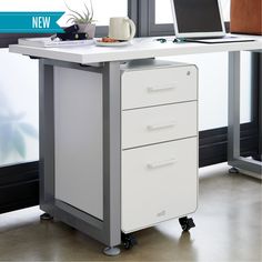 a white desk with two drawers and a laptop on it