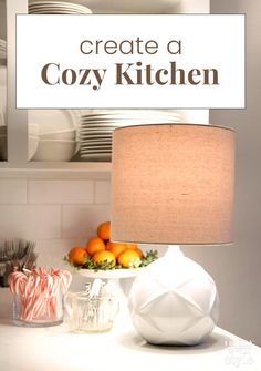 a white lamp sitting on top of a table next to oranges and candy canes