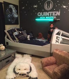 two children are playing in a star wars themed bedroom