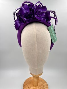 Elevate your look with our floral headband! This beautiful accessory features purple flowers and boit goose feathers for added flair. This headband is both durable and comfortable  🖤 Perfect for special occasions, this elegant hat will elevate your style and make a bold fashion statement. 🖤Shipped in a sturdy (keepsake) box and packed with special love and care.  🖤Made in the UK - customised fascinator orders are welcome. Please send me a message and we can create something unique.  Terms & Conditions I hope you love your purchase however I gladly accept returns, exchanges and cancellations. Head pieces must be returned within 14 days with all tags attached for a full refund. Cancellation must be made within 2 days of purchase.  🖤Finally I would love to share in your special day so ple Purple Headpiece With Handmade Flowers For Kentucky Derby, Adjustable Purple Fascinator For Royal Ascot, Purple Handmade Flowers Headpiece For Kentucky Derby, Purple Headband Mini Hat For Wedding, Purple Fascinator With Handmade Flowers For Spring, Adjustable Purple Headpiece For Formal Events, Elegant Purple Headband For Kentucky Derby, Purple Wedding Mini Hat Headband, Purple Feather Mini Hat For Wedding