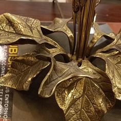 a golden flower sculpture sitting on top of a table